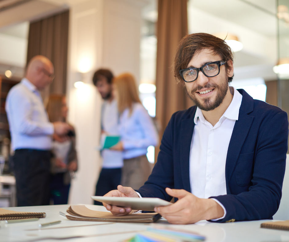 male small business manager holding the company's employee handbook